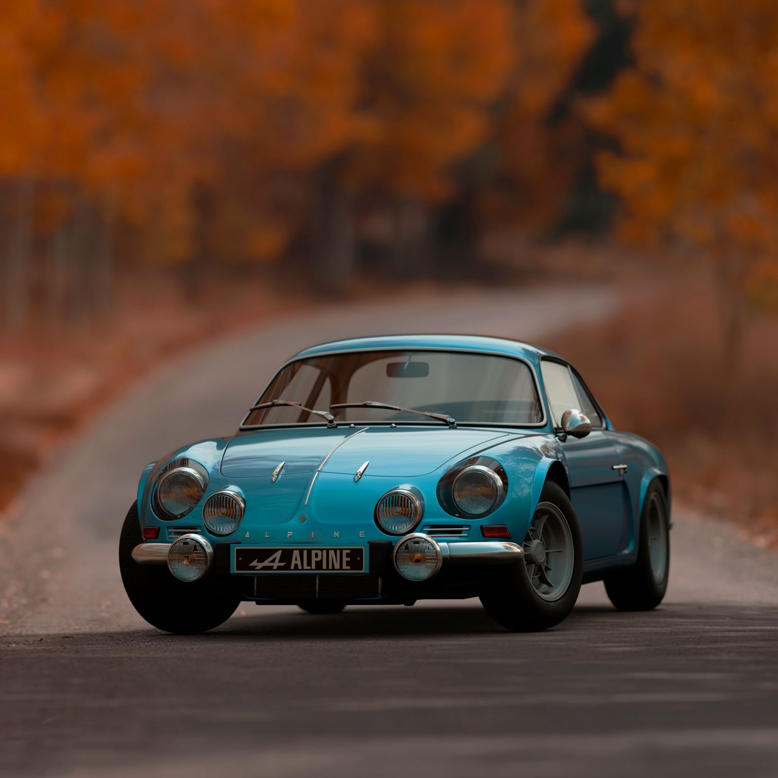 Classic blue sports car on an autumn road